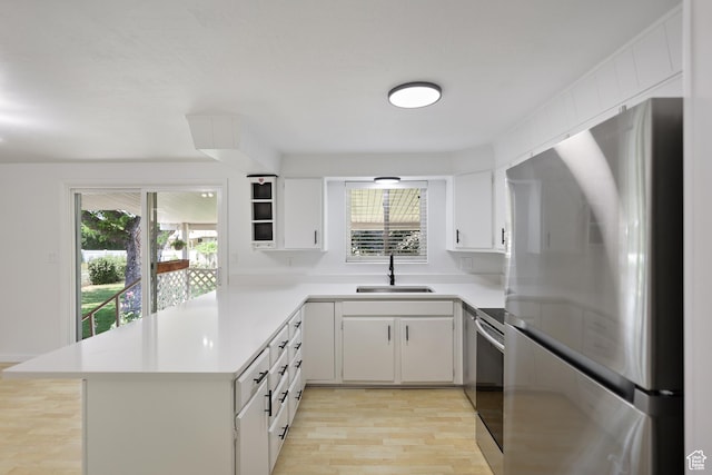 533 N 700 E, Orem, UT 84097 - kitchen with stainless steel appliances, a sink, light wood-style floors, light countertops, and white cabinetry