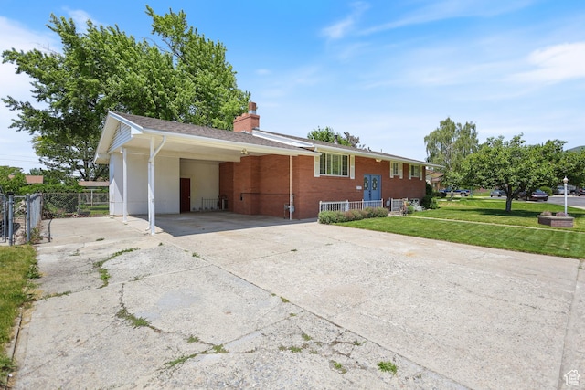 533 N 700 E, Orem, UT 84097 - view of property exterior with driveway, an attached carport, a chimney, and brick siding
