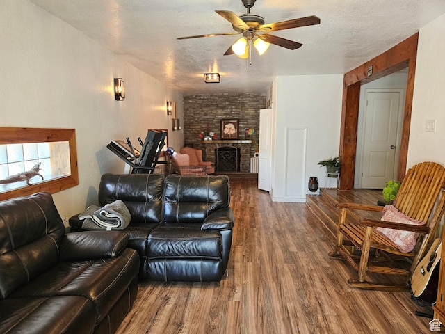 920 N 100 E, Pleasant Grove, UT 84062 - living area featuring a ceiling fan, wood finished floors, a fireplace, and a textured ceiling