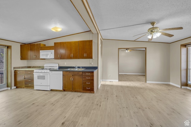 454 E 100 N, Moab, UT 84532 - kitchen with white appliances, brown cabinetry, lofted ceiling, light wood finished floors, and a sink