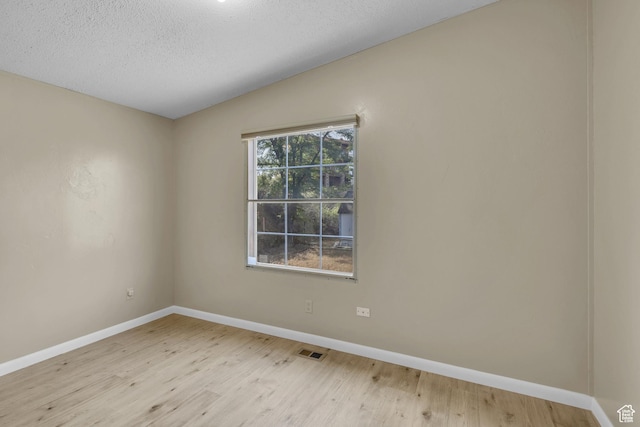 454 E 100 N, Moab, UT 84532 - spare room featuring wood finished floors, baseboards, vaulted ceiling, and a textured ceiling