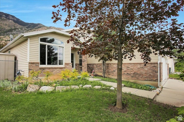 1422 N Fowler Ave E, Ogden, UT 84404 - view of front of home featuring brick siding, a mountain view, and a garage