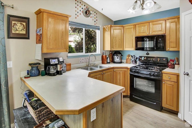 1422 N Fowler Ave E, Ogden, UT 84404 - kitchen with black appliances, a sink, a peninsula, light countertops, and light wood finished floors