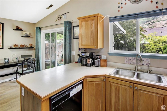 1422 N Fowler Ave E, Ogden, UT 84404 - kitchen with black dishwasher, a sink, lofted ceiling, light countertops, and a peninsula