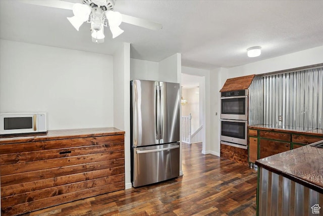 263 W 800 N, Brigham City, UT 84302 - kitchen with stainless steel appliances, dark wood-style floors, dark countertops, a ceiling fan, and baseboards