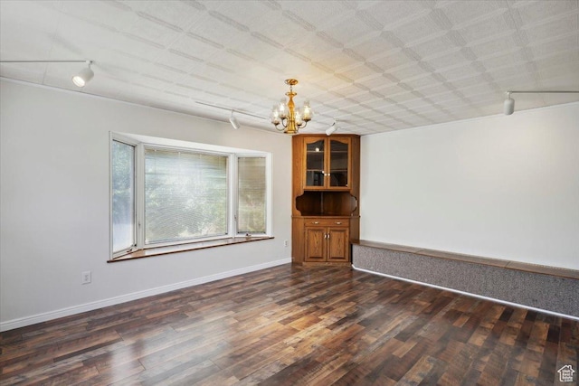 263 W 800 N, Brigham City, UT 84302 - spare room featuring a chandelier, track lighting, dark wood-style flooring, and baseboards