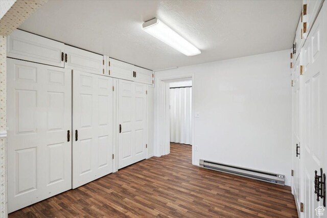 263 W 800 N, Brigham City, UT 84302 - unfurnished bedroom with baseboard heating and dark wood finished floors