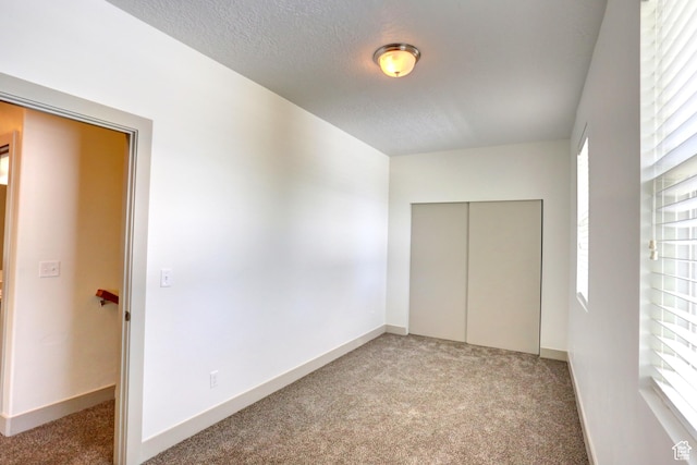 247 E 700 N, Spanish Fork, UT 84660 - unfurnished bedroom featuring light carpet, a closet, a textured ceiling, and baseboards