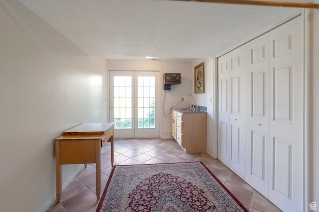 5760 S 1050 E, South Ogden, UT 84405 - doorway to outside with light tile patterned floors, baseboards, and a textured ceiling