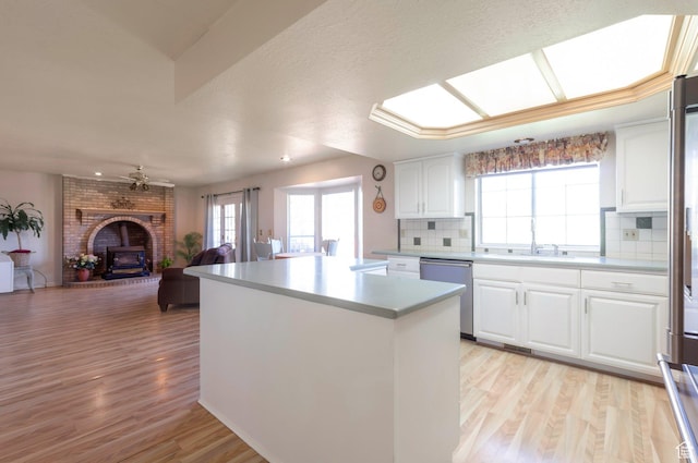 5760 S 1050 E, South Ogden, UT 84405 - kitchen with dishwasher, a center island, open floor plan, backsplash, and light wood-style floors