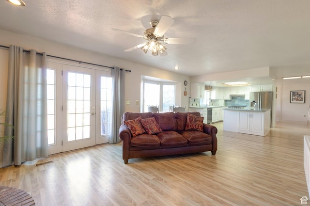 5760 S 1050 E, South Ogden, UT 84405 - living room featuring light wood-style floors, a textured ceiling, ceiling fan, and french doors