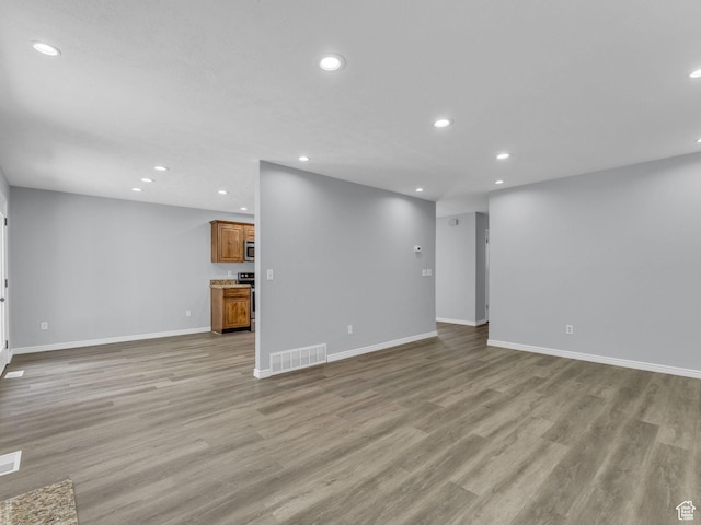 8335 S 1050 E, Sandy, UT 84094 - unfurnished living room featuring recessed lighting, baseboards, and light wood-style floors