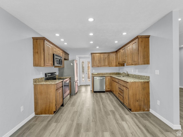 8335 S 1050 E, Sandy, UT 84094 - kitchen featuring stainless steel appliances, a sink, light wood-style floors, brown cabinets, and recessed lighting