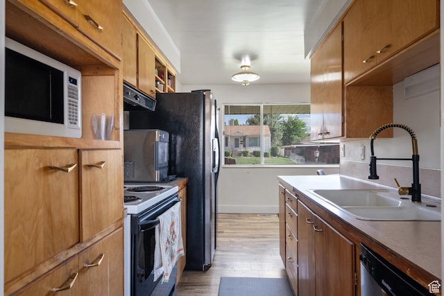 1185 E Hillcrest Dr, Springville, UT 84663 - kitchen with stainless steel appliances, a sink, light wood finished floors, and baseboards