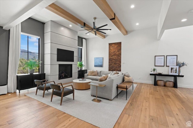 11527 S River Front Pkwy W, South Jordan, UT 84095 - living area with light wood finished floors, beam ceiling, a ceiling fan, recessed lighting, and baseboards