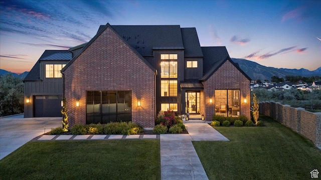 11527 S River Front Pkwy W, South Jordan, UT 84095 - view of front of home with a standing seam roof, brick siding, driveway, and board and batten siding