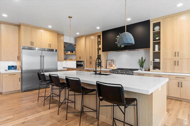 11527 S River Front Pkwy W, South Jordan, UT 84095 - kitchen with stainless steel appliances, light brown cabinetry, light wood finished floors, light countertops, and recessed lighting