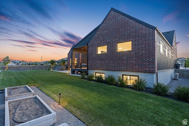 11527 S River Front Pkwy W, South Jordan, UT 84095 - view of side of home with a vegetable garden, a yard, and brick siding