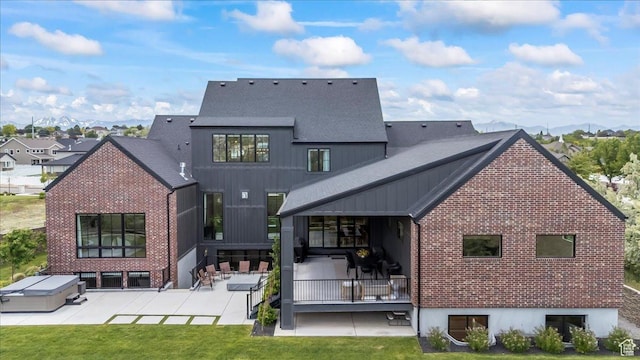 11527 S River Front Pkwy W, South Jordan, UT 84095 - rear view of property with a patio, brick siding, and a lawn