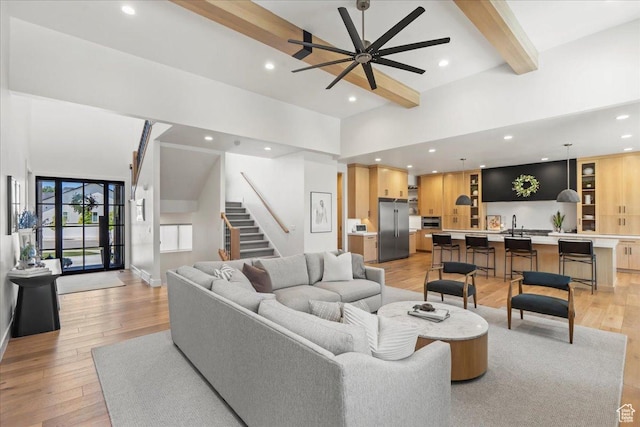 11527 S River Front Pkwy W, South Jordan, UT 84095 - living area featuring beamed ceiling, a ceiling fan, light wood finished floors, stairs, and recessed lighting