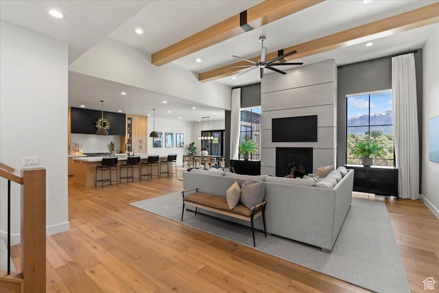 11527 S River Front Pkwy W, South Jordan, UT 84095 - living area with beam ceiling, light wood finished floors, recessed lighting, a ceiling fan, and a large fireplace
