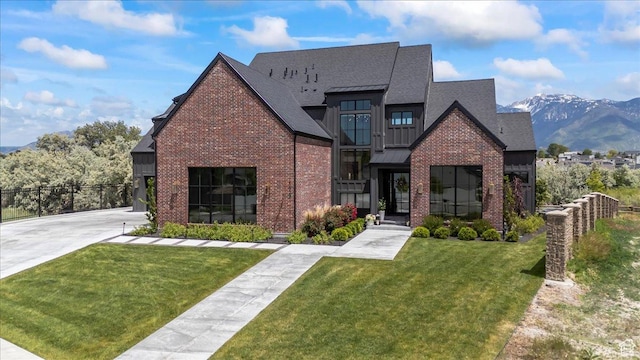 11527 S River Front Pkwy W, South Jordan, UT 84095 - view of front facade featuring brick siding, a mountain view, board and batten siding, and a shingled roof