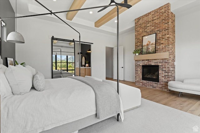 11527 S River Front Pkwy W, South Jordan, UT 84095 - bedroom with wood finished floors, beam ceiling, a fireplace, recessed lighting, and a high ceiling