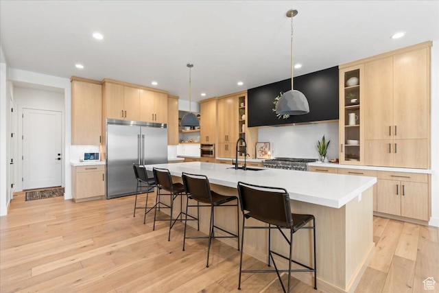 11527 S River Front Pkwy W, South Jordan, UT 84095 - kitchen featuring stainless steel appliances, light brown cabinetry, light wood-style floors, a spacious island, and recessed lighting