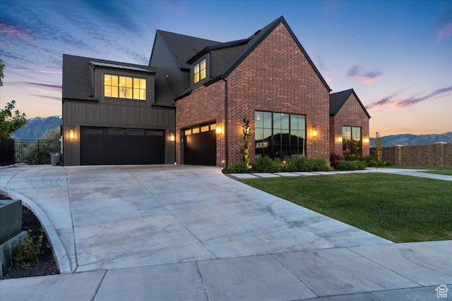 11527 S River Front Pkwy W, South Jordan, UT 84095 - view of front of home featuring brick siding, driveway, an attached garage, and board and batten siding