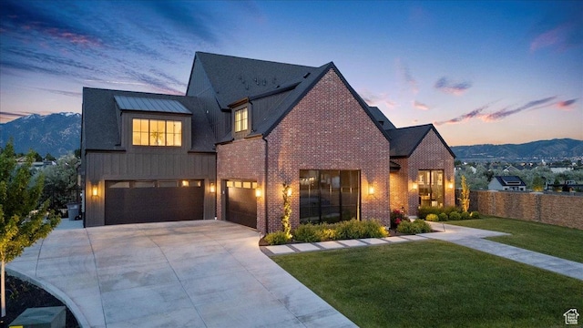 11527 S River Front Pkwy W, South Jordan, UT 84095 - view of front of house featuring an attached garage, driveway, brick siding, and a mountain view