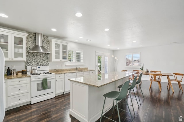 157 N Keogh Ln W, Ogden, UT 84404 - kitchen featuring white appliances, wall chimney exhaust hood, plenty of natural light, a sink, and recessed lighting