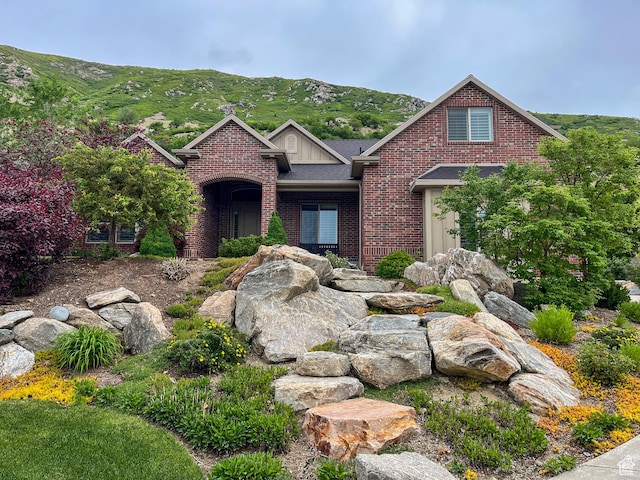 66 N 325th St E, Farmington, UT 84025 - traditional-style home with brick siding, a mountain view, and a shingled roof