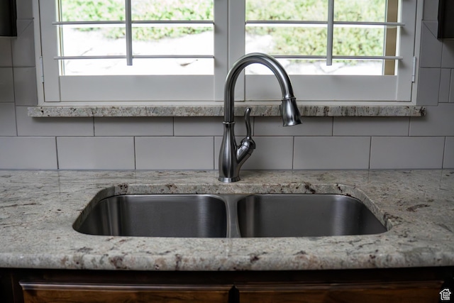 66 N 325th St E, Farmington, UT 84025 - kitchen view of a sink, decorative backsplash, and light stone counters