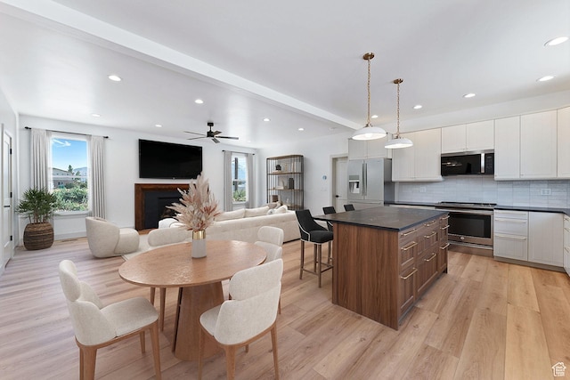 1136 W 1450 S, Lehi, UT 84043 - kitchen with stainless steel appliances, dark countertops, a center island, white cabinets, and decorative backsplash