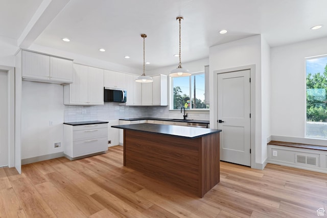 1136 W 1450 S, Lehi, UT 84043 - kitchen with stainless steel microwave, tasteful backsplash, a sink, a center island, and recessed lighting