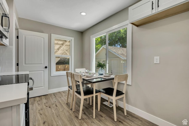 8689 W Edith Dr, Magna, UT 84044 - dining space featuring baseboards, light wood-style flooring, and recessed lighting