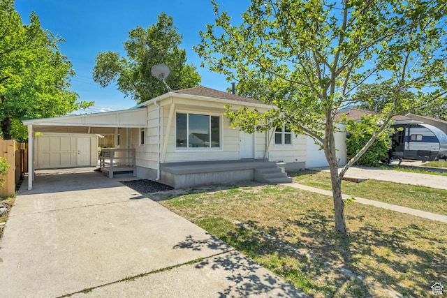 8689 W Edith Dr, Magna, UT 84044 - view of front facade with driveway, an attached carport, and covered porch