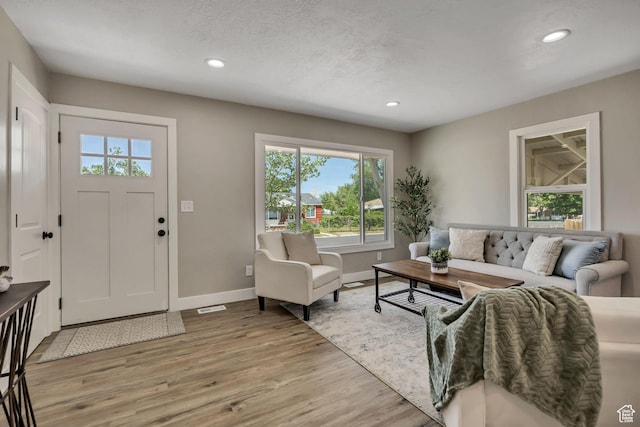 8689 W Edith Dr, Magna, UT 84044 - living room featuring recessed lighting, baseboards, and light wood-style floors