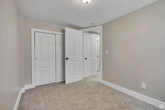 8689 W Edith Dr, Magna, UT 84044 - unfurnished bedroom featuring light carpet, baseboards, a textured ceiling, and a closet