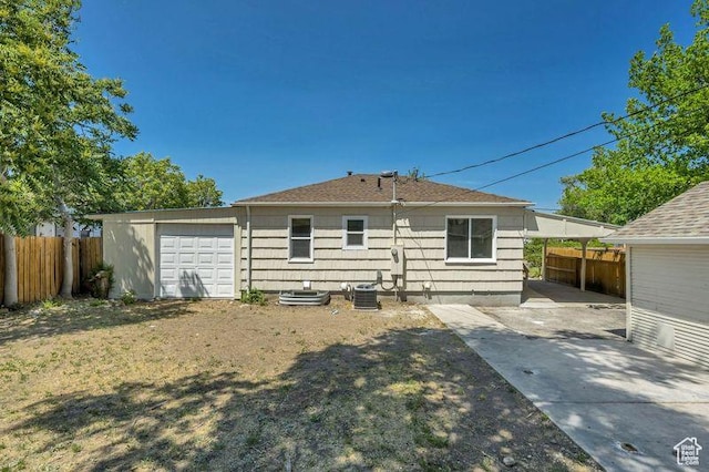 8689 W Edith Dr, Magna, UT 84044 - back of house featuring cooling unit and a garage