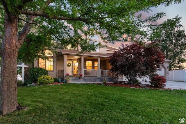2271 W Pointe Meadow Dr N, Lehi, UT 84043 - obstructed view of property featuring a porch, a front yard, stone siding, and a garage