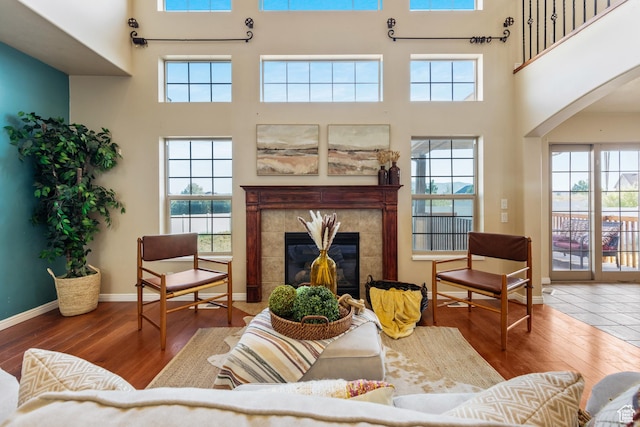2271 W Pointe Meadow Dr N, Lehi, UT 84043 - living room with a towering ceiling, wood-type flooring, a fireplace, arched walkways, and baseboards