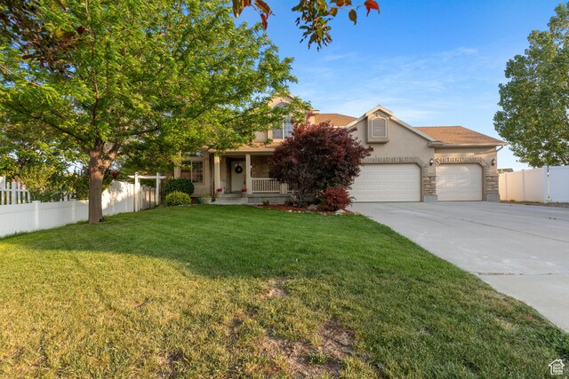 2271 W Pointe Meadow Dr N, Lehi, UT 84043 - obstructed view of property featuring stucco siding, concrete driveway, a garage, a porch, and stone siding
