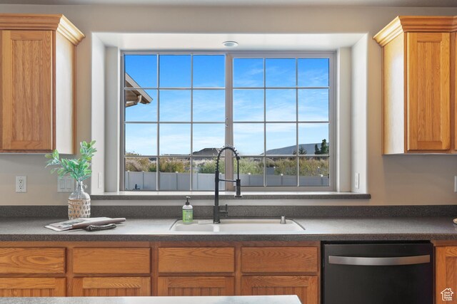 2271 W Pointe Meadow Dr N, Lehi, UT 84043 - kitchen featuring stainless steel dishwasher, a sink, dark countertops, and brown cabinetry