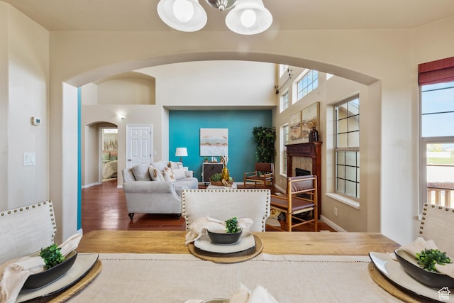 2271 W Pointe Meadow Dr N, Lehi, UT 84043 - living room with arched walkways, wood finished floors, a fireplace, and a chandelier