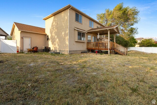 2271 W Pointe Meadow Dr N, Lehi, UT 84043 - back of property featuring a wooden deck, stucco siding, and cooling unit