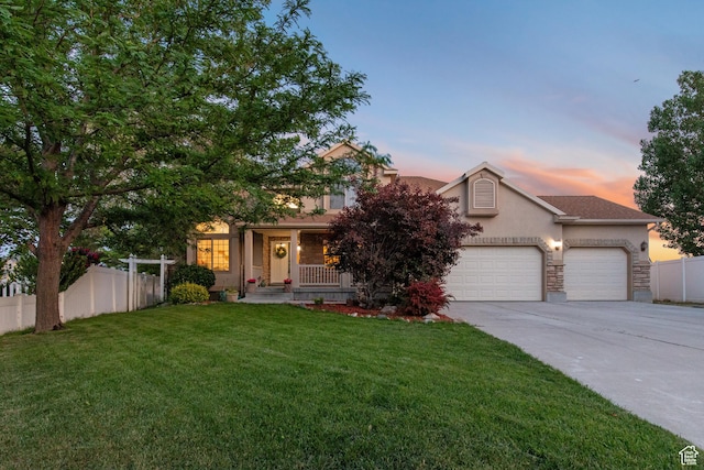 2271 W Pointe Meadow Dr N, Lehi, UT 84043 - obstructed view of property with stucco siding, concrete driveway, a garage, covered porch, and stone siding