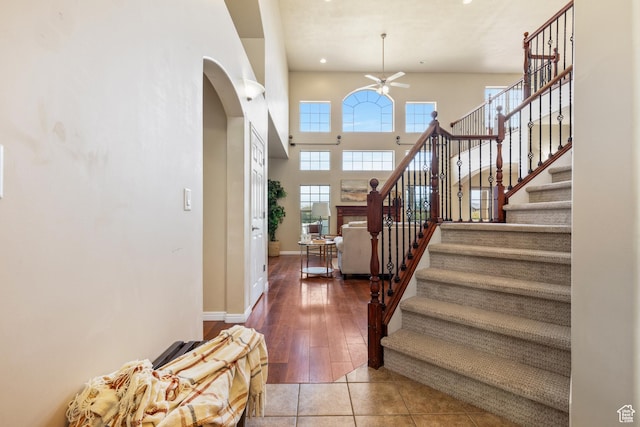 2271 W Pointe Meadow Dr N, Lehi, UT 84043 - tiled entrance foyer featuring ceiling fan, arched walkways, stairway, a high ceiling, and baseboards