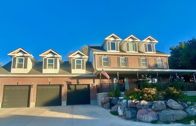 4433 Devonshire Dr W, Bountiful, UT 84010 - view of front of home featuring brick siding, a garage, driveway, and covered porch