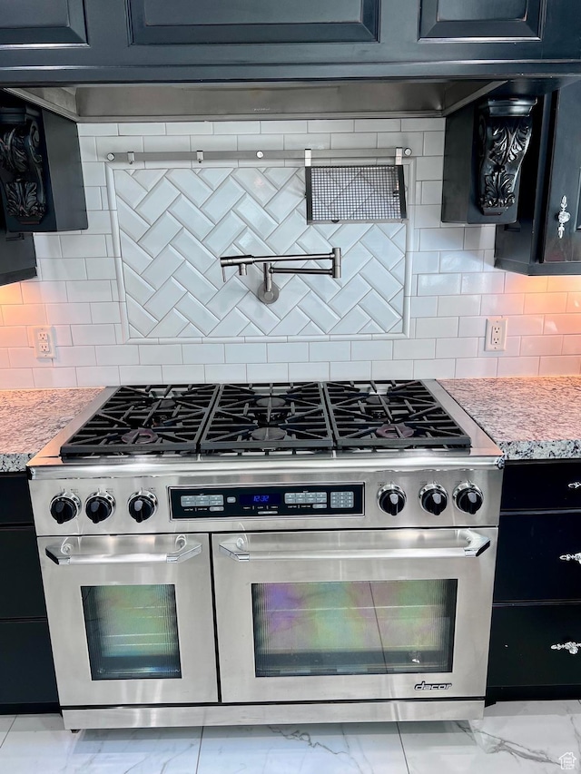 4433 Devonshire Dr W, Bountiful, UT 84010 - kitchen featuring stainless steel range with gas cooktop, light marble finish flooring, tasteful backsplash, and light stone counters